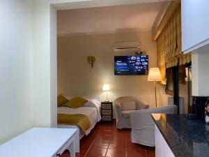 a hotel room with a bed and a tv on the wall at Alvor Seven 10 in Alvor