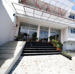 a building with a bunch of stairs in front of it at The Aurora by Makati in Lembang