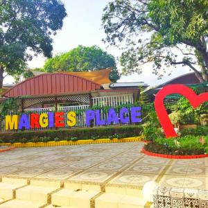 a sign in front of a building with a heart at Margie's Place and Coffee Shop Inc. in Mariveles