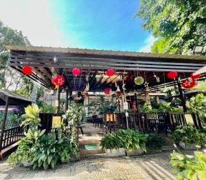 a patio with tables and chairs and red lanterns at Margie's Place and Coffee Shop Inc. in Mariveles