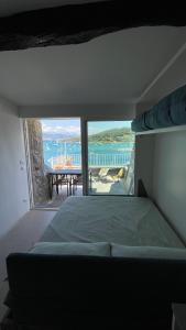 a bedroom with a bed and a view of the ocean at Seafront rooftop flat w/ terrace in Portovenere