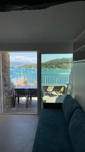 a living room with a view of the ocean at Seafront rooftop flat w/ terrace in Portovenere