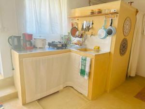 a small kitchen with a counter and a sink at Takasira Appart Hotel centre ville in Fort Dauphin +16 photos