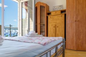 a bedroom with a bed and a large window at Apartment Ivana Makarska in Veliko Brdo