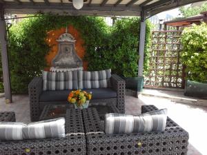 a patio with a couch and a table with flowers at Alba B&B in Isernia