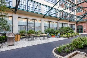 a building with tables and chairs in a courtyard at Kendall Sq 2BR w Gym nr MIT Mass General BOS-665 in Boston