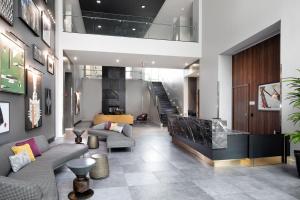a lobby with couches and a staircase in a building at E Cambridge studio w WD Gym steps from Train BOS-522 in Boston