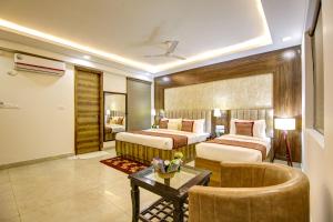 Habitación de hotel con 2 camas y mesa en Hotel The Prithvi, Near Delhi Airport, en Nueva Delhi