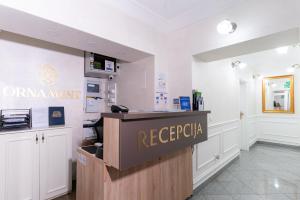 a reception area of a hospital with a sign on a counter at Ornament Hotel in Sarajevo