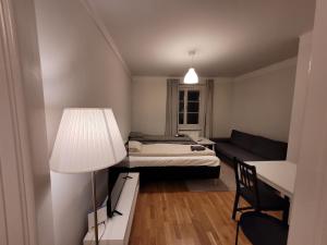 a living room with a bed and a couch at Home Inn KG49 in Stockholm