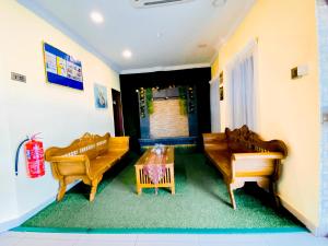 a living room with two couches and a table at Sun Inns Hotel Bandar Puchong Utama in Puchong