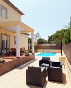 a patio with furniture and a swimming pool at Isla Verde y Mar in Isla Cristina