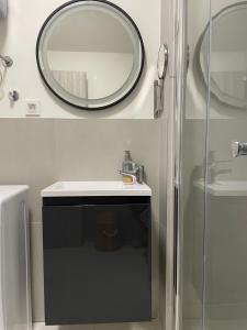 a bathroom with a mirror and a sink at Vitas Apartments in Zaton