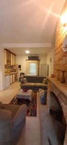 a living room with a couch and a stone fireplace at 250m to the Beach - Fully Furnished - Fast Wi-Fi in Marmaris