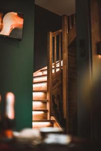 a wooden staircase in a room with a green wall at BLACK HOUSE - premium holiday guest house in Priedkalne