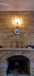 a stone fireplace with a mirror on a stone wall at 250m to the Beach - Fully Furnished - Fast Wi-Fi in Marmaris