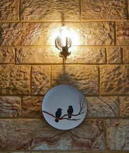 a plate on a brick wall with two birds on a branch at 250m to the Beach - Fully Furnished - Fast Wi-Fi in Marmaris