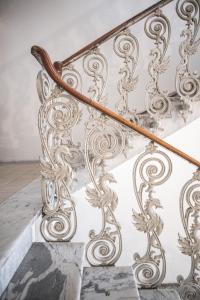 an ornate metal railing on a stairway at Palazzo Zippitelli Apartments in Bari