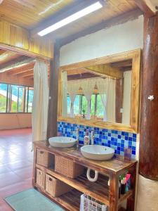 a bathroom with two sinks and a large mirror at Moc Home Sapa in Sapa