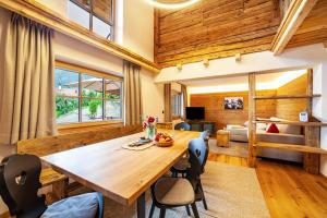 a dining room with a wooden table and chairs at Ferienhaus Mutlechnerhof in Caines
