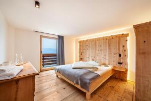 - une chambre avec un grand lit et une fenêtre dans l'établissement Ferienhaus Mutlechnerhof, à Caines