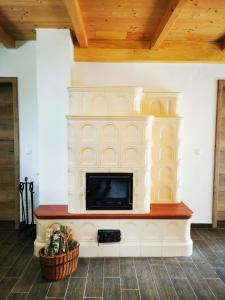 a living room with a fireplace with a tv at Holiday Home - Goričko Park 