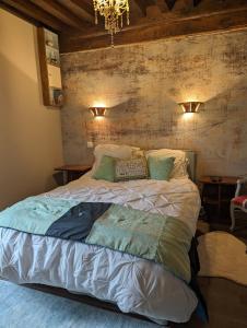 um quarto com uma cama grande e 2 almofadas em Chez Nick et Martine suite privative em Palinges