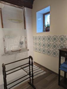 a bathroom with a bench and a window at Chez Nick et Martine suite privative in Palinges