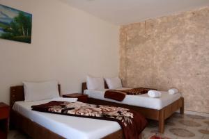 a room with two beds in a room at Bedouins Inn Village in Aqaba