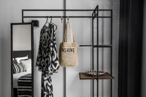 a black and white bedroom with a bed and a bag at KASerne Boutique Hotel in Den Bosch