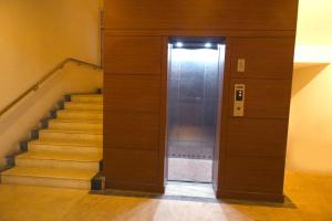 an elevator in a building with a staircase at SET Residency in Kumbakonam