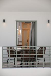 a dining room with a table and chairs and a mirror at Makava Suites Naxos in Naxos Chora