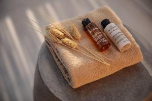 a table with two bottles of essential oils and wheataments at "Makava Suites" Your Luxe Urban Sanctuary in Naxos Chora