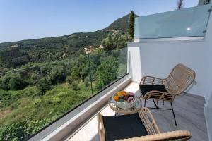 a balcony with a table and chairs and a view at Gaia Apartments Parga in Parga