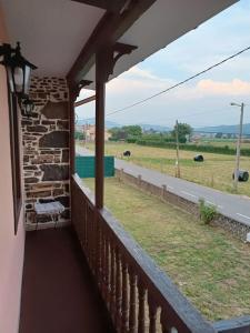 a balcony of a house with a view of a field at Casa rural en Sariego in Villar