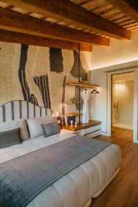 a bedroom with a large bed with a wall mural at Casa Indiana Hotel Boutique in Blanes