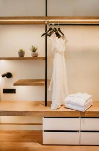 a wedding dress hanging on a rack in a room at Casa Indiana Hotel Boutique in Blanes
