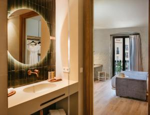 a bathroom with a sink and a mirror at Casa Indiana Hotel Boutique in Blanes