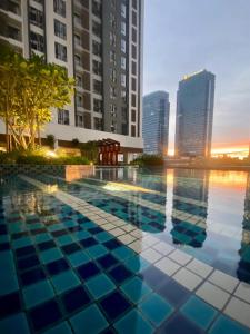 a swimming pool in a city with tall buildings at Sentral Suites By RKD HOME in Kuala Lumpur
