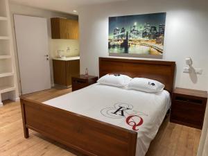 a bedroom with a large bed with a picture on the wall at Studio near the sea in Netanya