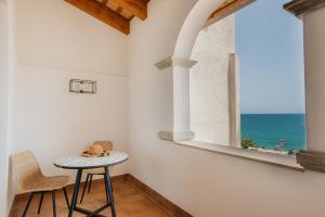 a table and two chairs in a room with a window at Casa Indiana Hotel Boutique in Blanes