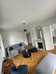 a living room with a couch and a fireplace at Le grand Michelet centre de tours in Tours