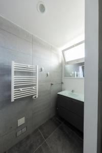a bathroom with a sink and a tub and a window at Dune Front Paradise - Appartement sur la dune in Soorts-Hossegor