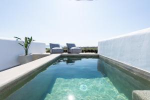 a swimming pool in the backyard of a house at Sersi Paros Villas & Suites in Kampos Paros