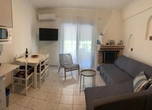 a living room with a couch and a table at Alma Sea House in Hanioti