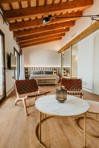 a living room with a table and chairs and a bed at Casa Indiana Hotel Boutique in Blanes