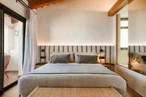 a bedroom with a large bed with two pillows at Casa Indiana Hotel Boutique in Blanes