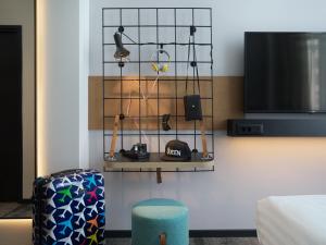 a room with a shelf with items on it at Moxy Belgrade in Belgrade