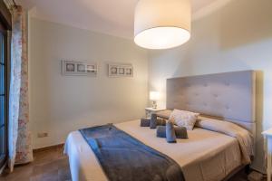 a bedroom with a large bed in a room at Las Palmeras by Ĥ - Playa Punta del Moral PLHP28P11 in Isla del Moral +32 photos