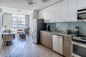 a kitchen with a refrigerator and a table in it at San Jose 1br w gym pool wd nr San Pedro Sq SFO-1312 in San Jose